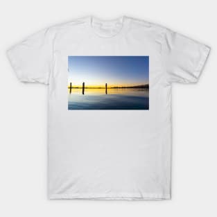 Sweeping lines of Tauranga's historic railway bridge with sunrising on left cast golden hues across harbor T-Shirt